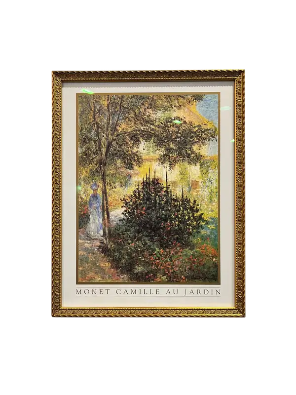 Framed art print featuring a painting of a woman in a garden, with a gold-colored frame. Camille Monet in the Garden Framed Print | Art Glass