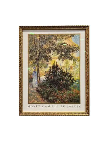 Framed art print featuring a painting of a woman in a garden, with a gold-colored frame. Camille Monet in the Garden Framed Print | Art Glass