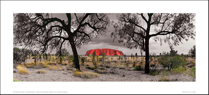 A framed photograph of Uluru, also known as Ayers Rock, surrounded by desert landscape with trees in the foreground. The image includes a facsimile signature by Ken Duncan on the bottom right.