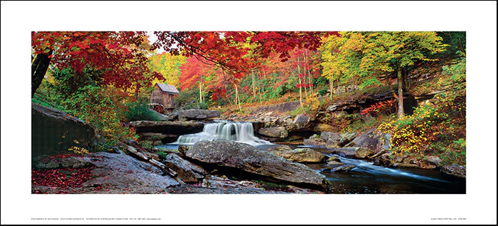 A framed color photograph of Glade Creek Grist Mill with autumn colors, including trees in red, orange, and green, and a silver foil signature on the bottom right.