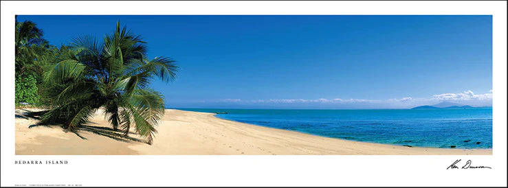 A framed panoramic print depicting a tropical beach scene with palm trees, sandy beach, and blue ocean.
