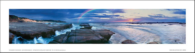 A photograph featuring the Norah Head coastal area with a rainbow over the ocean, signed by Ken Duncan.