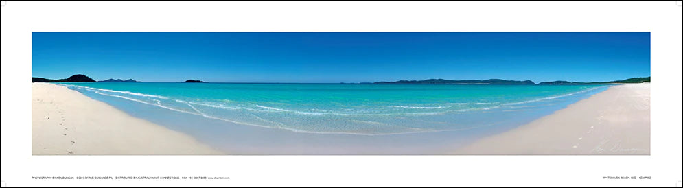 Panoramic photograph of Whitehaven Beach with clear blue skies, turquoise ocean, and white sand. Includes facsimile signature by Ken Duncan in silver foil on the bottom right.